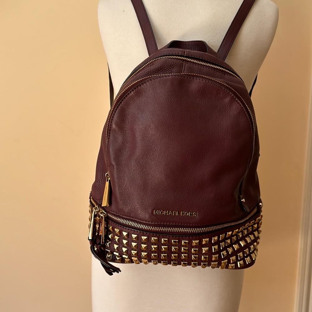 Michael Kors burgundy leather backpack.